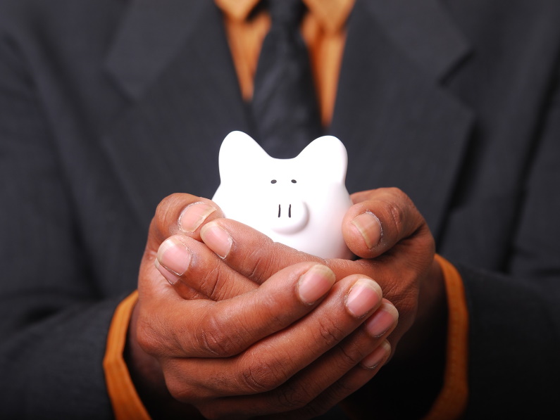 man holding a piggy bank in his hands