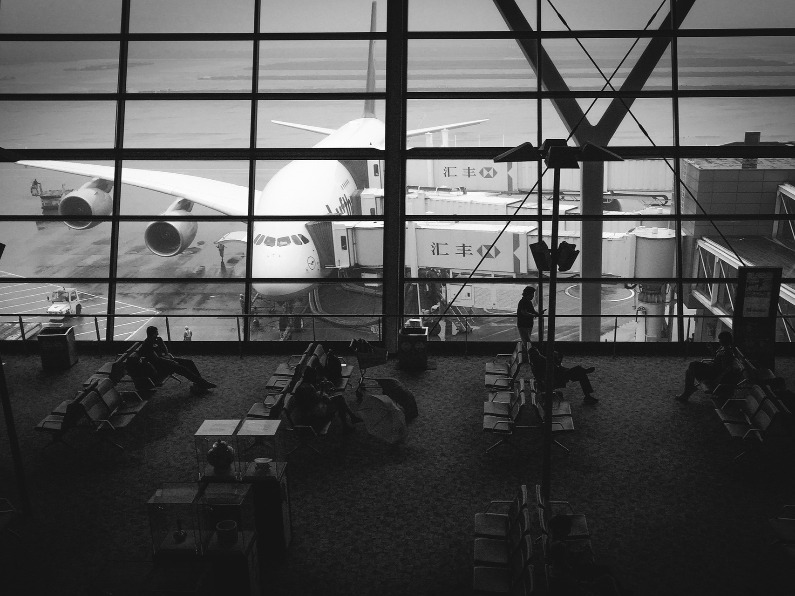 inside of an airport with a view of an airplane outside the window
